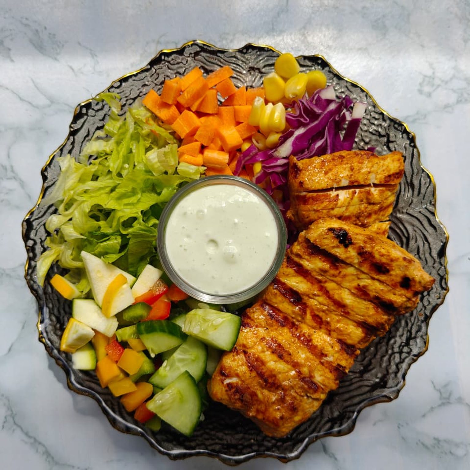 Grilled Chicken Salad bowl with fresh vegetables and a dressing cup