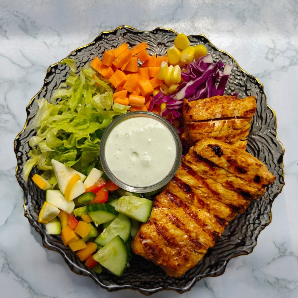Grilled Chicken Salad with lettuce, carrot, corn, red cabbage and a dressing cup